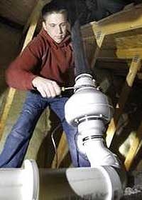 worker installing radon mitigation system